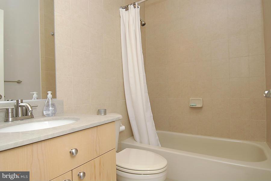 1360 Monroe Street Northwest, Unit B Washington, DC 20010 - Photo 16 of 19 a bathroom with a granite countertop sink toilet and shower