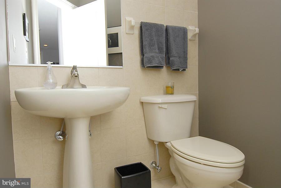 1360 Monroe Street Northwest, Unit B Washington, DC 20010 - Photo 8 of 19 a bathroom with a toilet sink and mirror