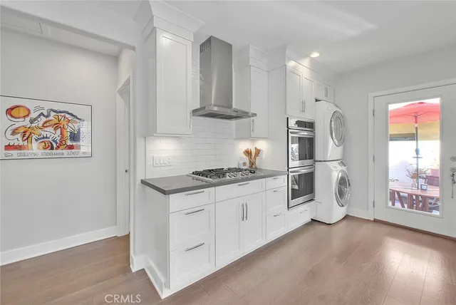 a kitchen with stainless steel appliances granite countertop a stove and a refrigerator