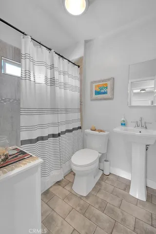 a bathroom with a sink a toilet and a shower