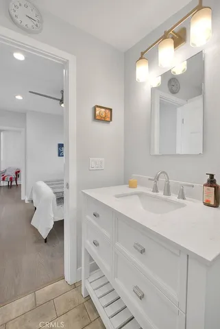 a bathroom with a sink vanity and mirror