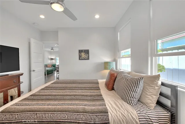 a bedroom with a large bed and a flat screen tv