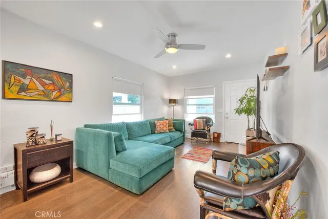 a living room with furniture and wooden floor