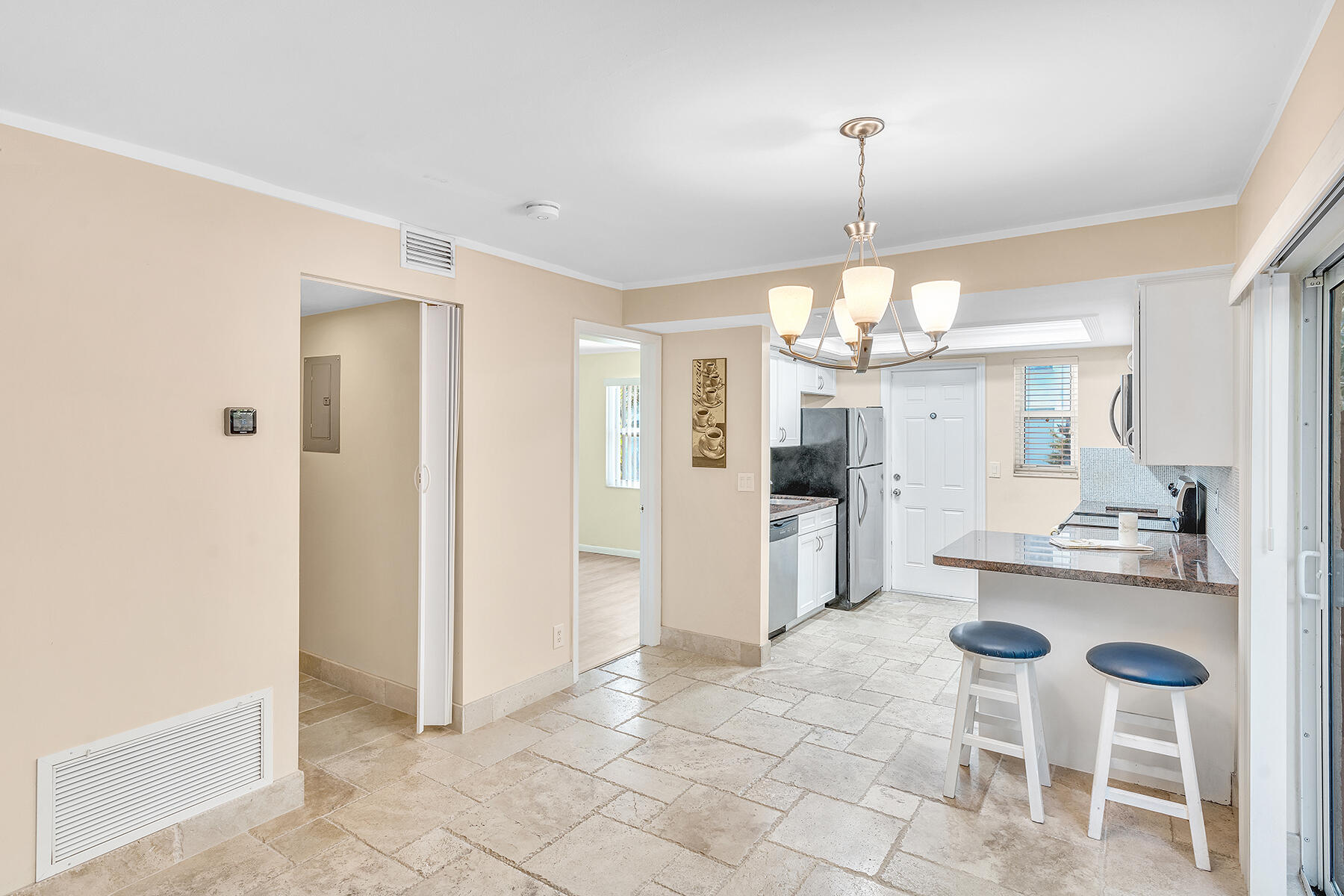 1945 Northwest 4th Avenue, Unit 32C Boca Raton, FL 33432 - Photo 18 of 52 a kitchen with refrigerator and cabinets