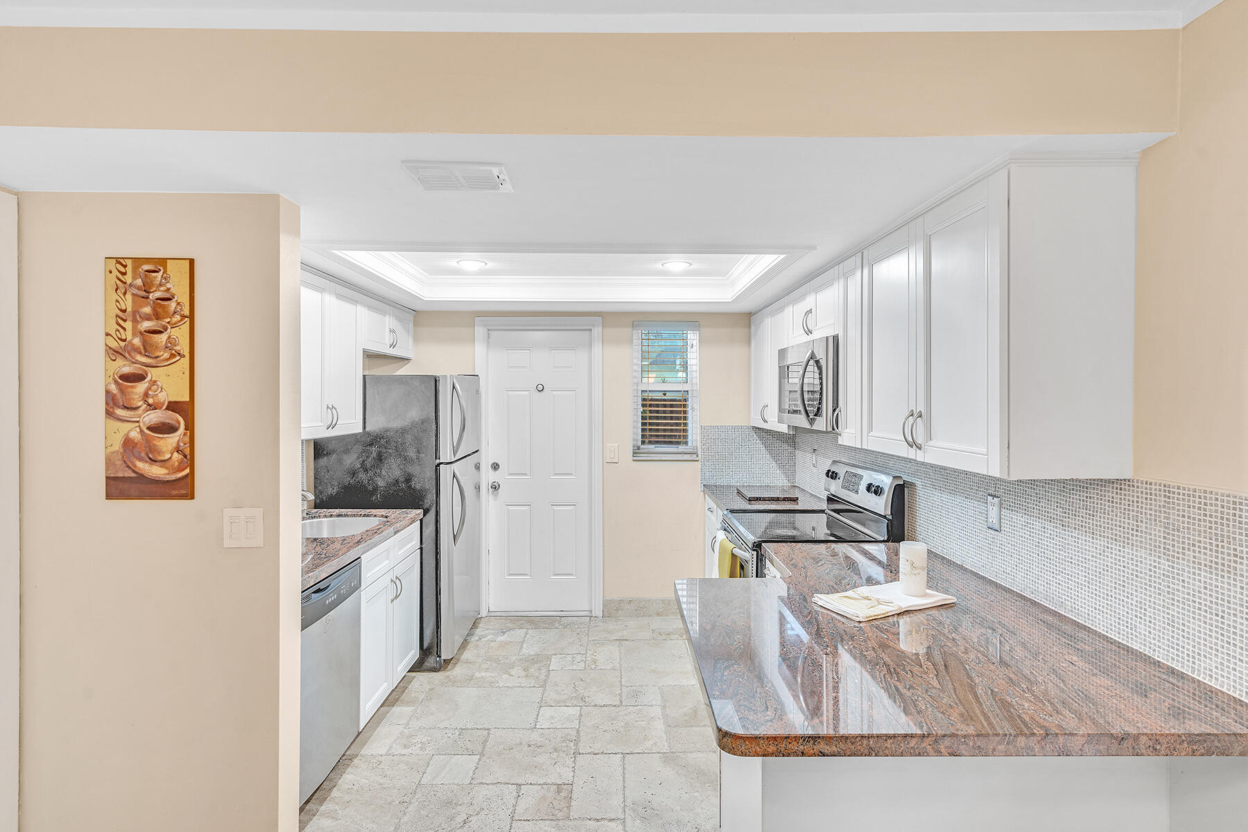 1945 Northwest 4th Avenue, Unit 32C Boca Raton, FL 33432 - Photo 20 of 52 a large kitchen with a large window in it and stainless steel appliances