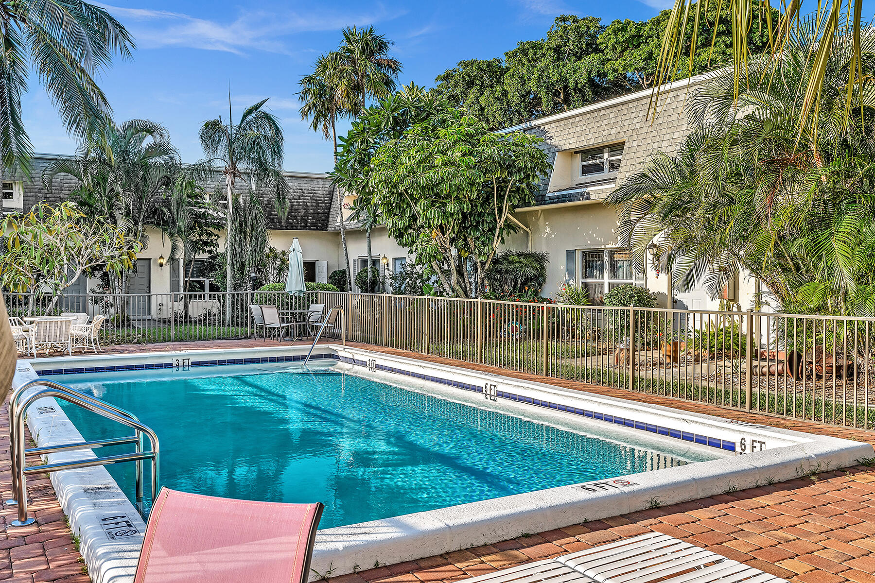 1945 Northwest 4th Avenue, Unit 32C Boca Raton, FL 33432 - Photo 2 of 52 a view of a patio with a table and chairs and potted plants
