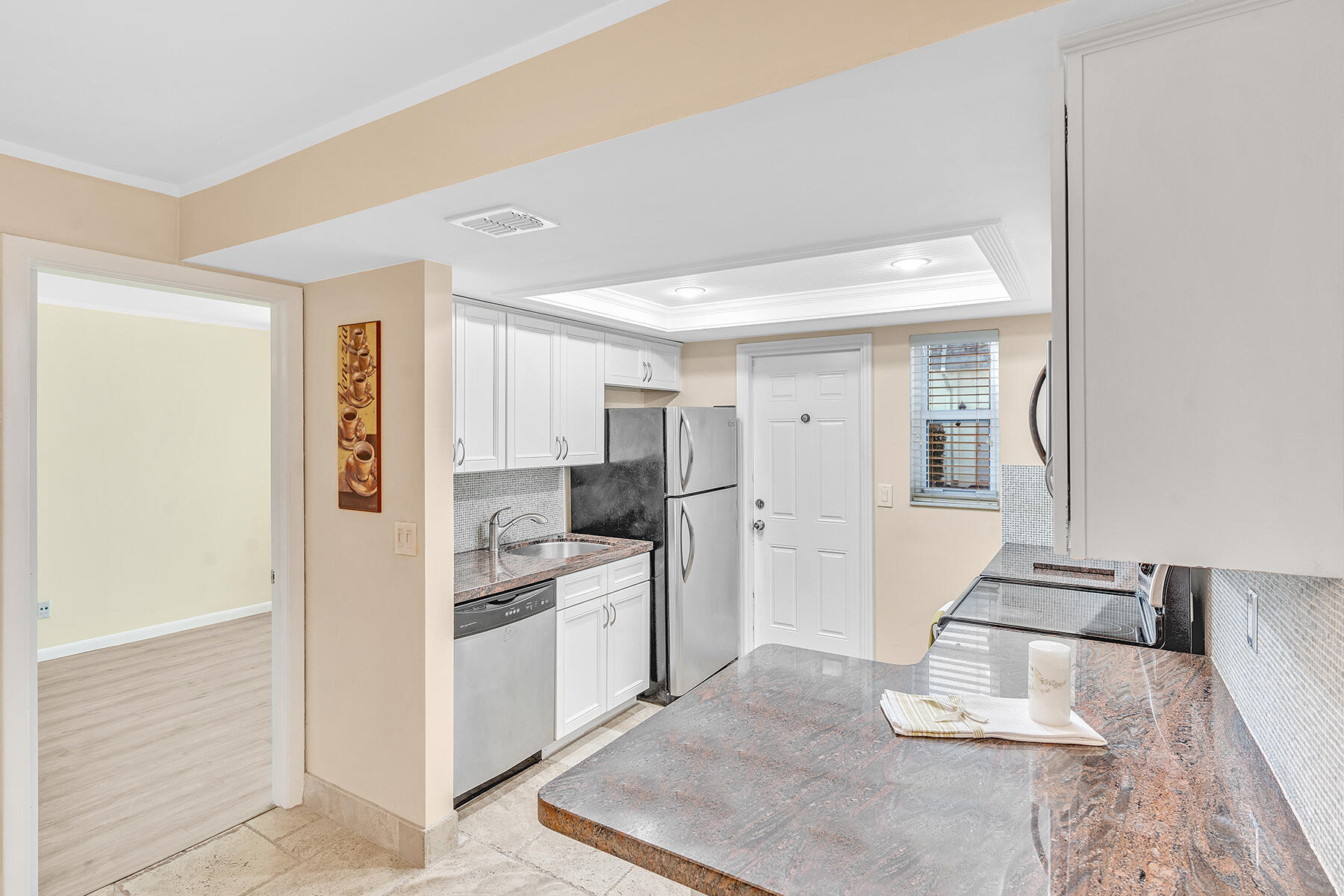 1945 Northwest 4th Avenue, Unit 32C Boca Raton, FL 33432 - Photo 21 of 52 a kitchen with white cabinets and appliances