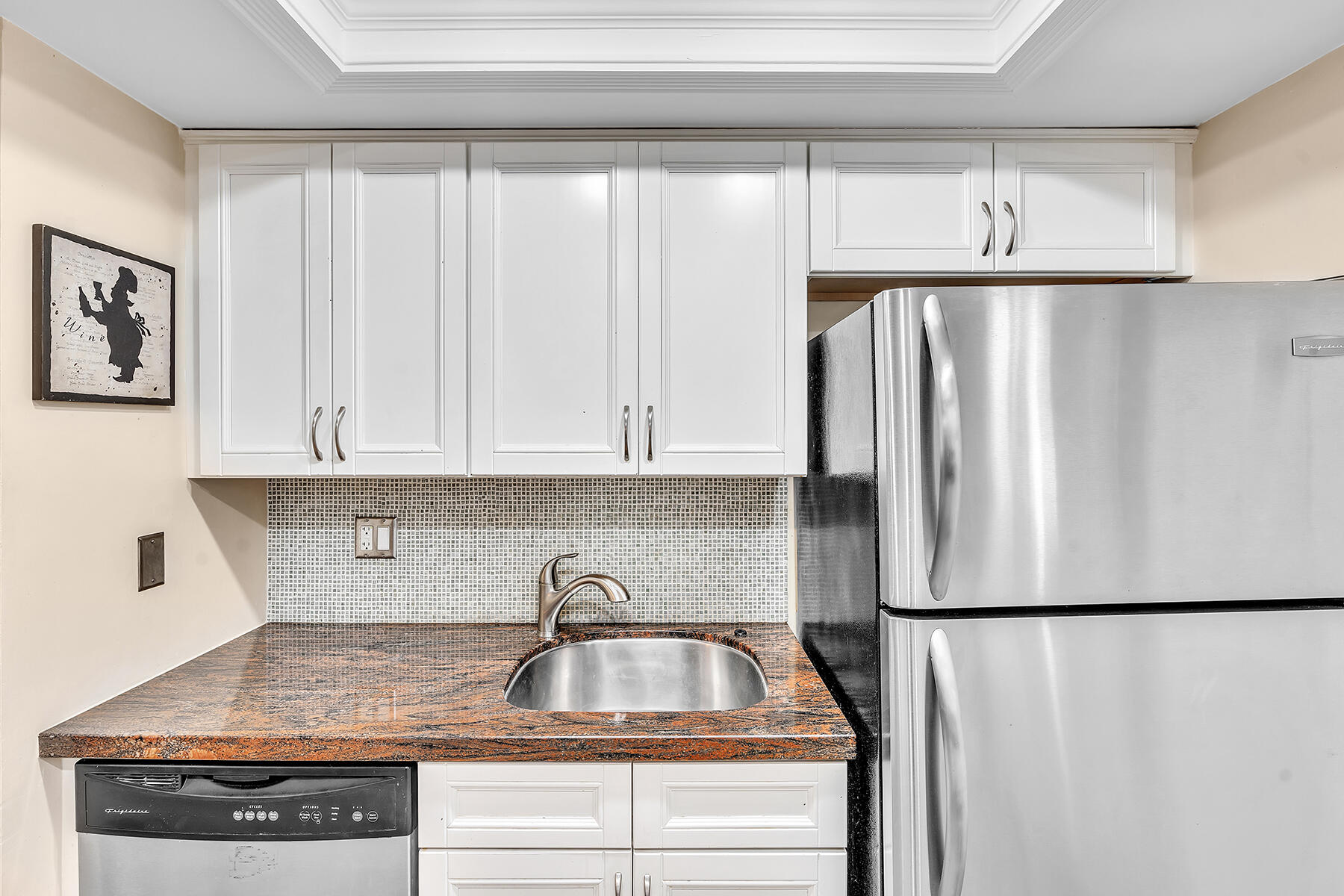 1945 Northwest 4th Avenue, Unit 32C Boca Raton, FL 33432 - Photo 26 of 52 a kitchen with a refrigerator and white cabinets