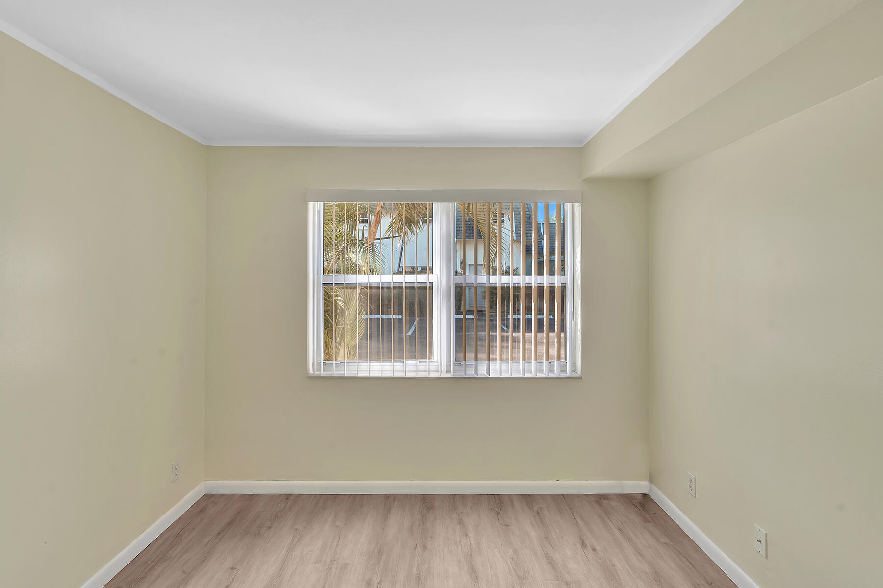 1945 Northwest 4th Avenue, Unit 32C Boca Raton, FL 33432 - Photo 28 of 52 a view of an empty room with wooden floor and a window
