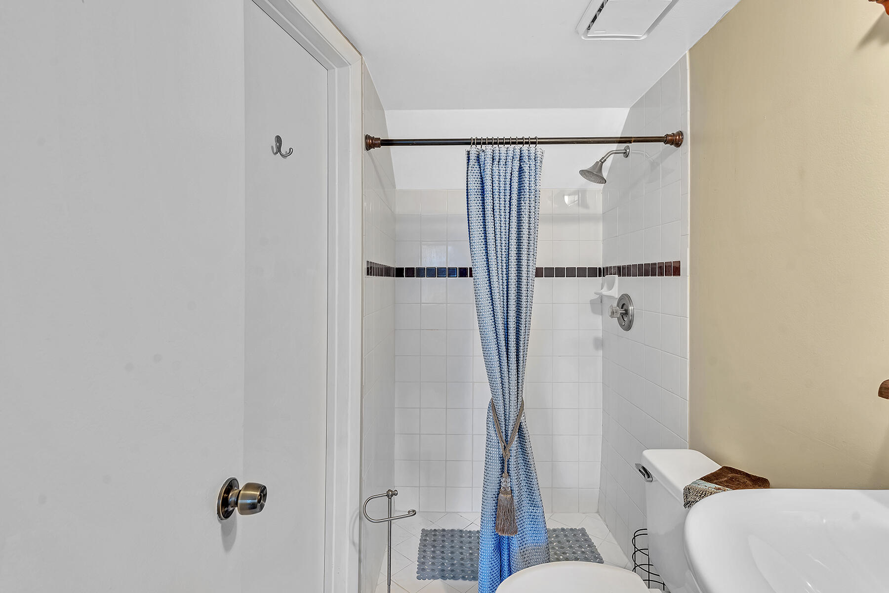 1945 Northwest 4th Avenue, Unit 32C Boca Raton, FL 33432 - Photo 30 of 52 a bathroom with a shower toilet and sink