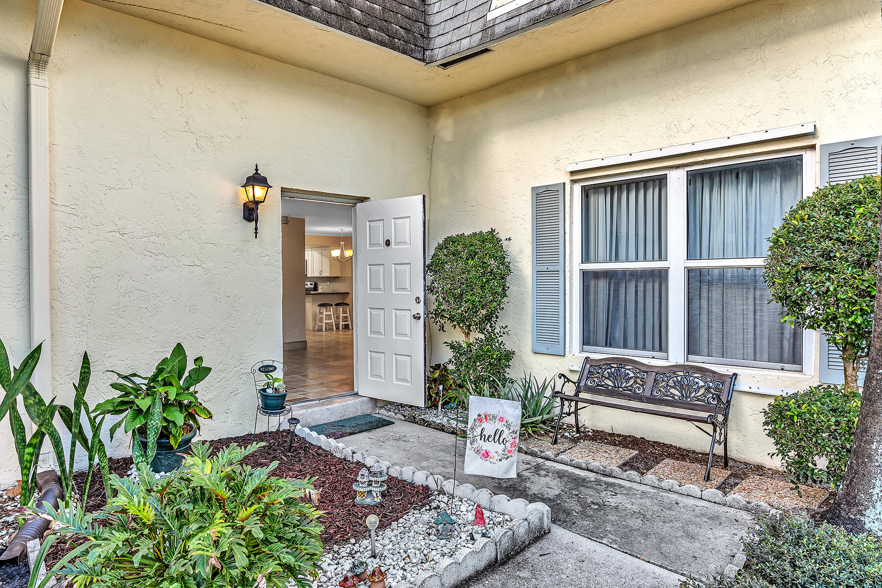 1945 Northwest 4th Avenue, Unit 32C Boca Raton, FL 33432 - Photo 3 of 52 a wooden bench sitting in backside of a house