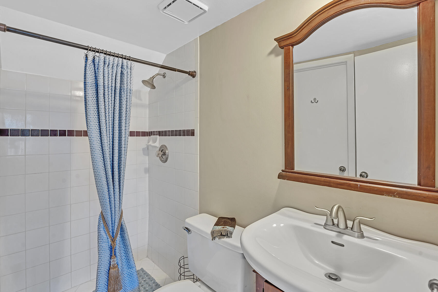 1945 Northwest 4th Avenue, Unit 32C Boca Raton, FL 33432 - Photo 31 of 52 a bathroom with a sink toilet and shower