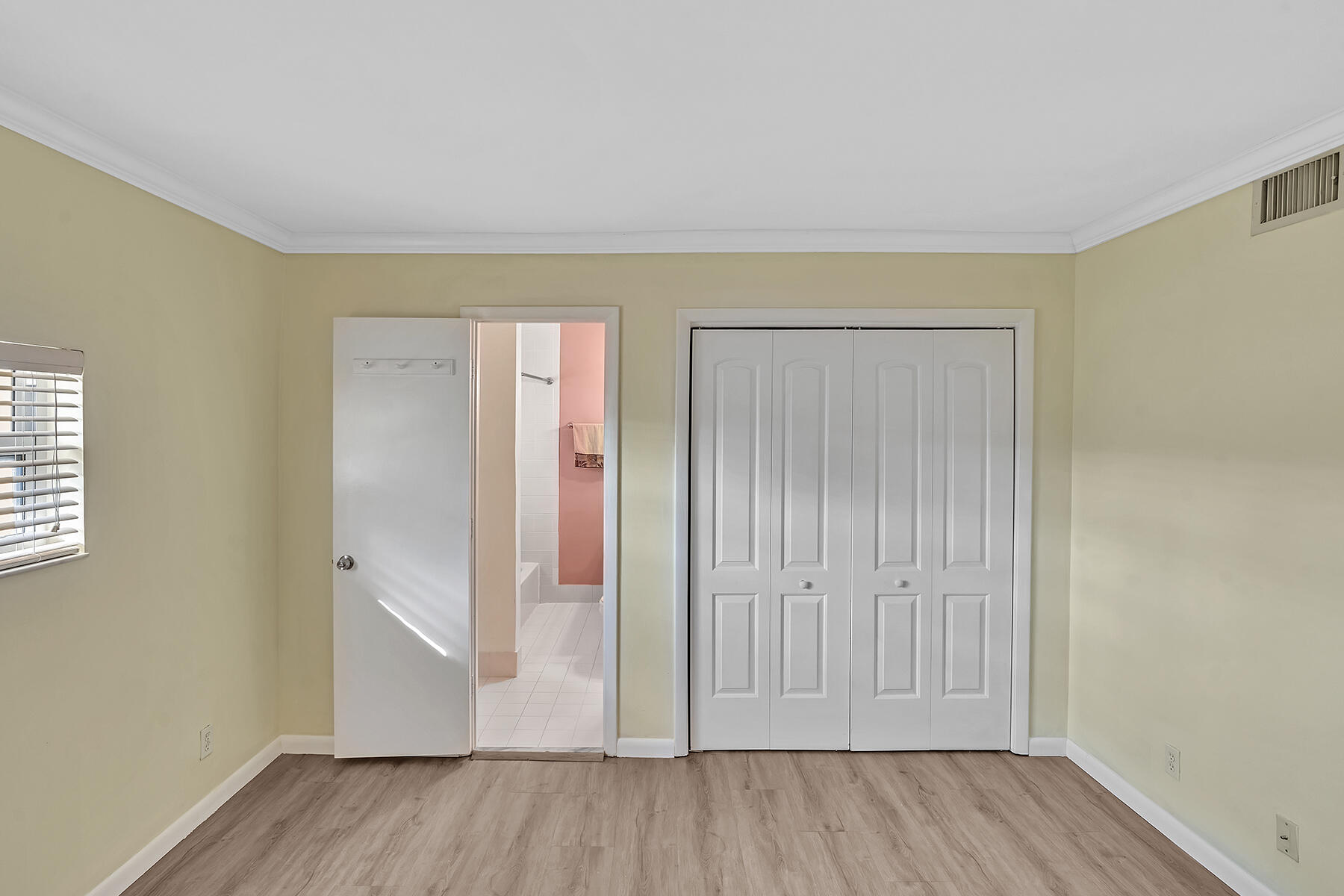 1945 Northwest 4th Avenue, Unit 32C Boca Raton, FL 33432 - Photo 37 of 52 an empty room with wooden floor and windows