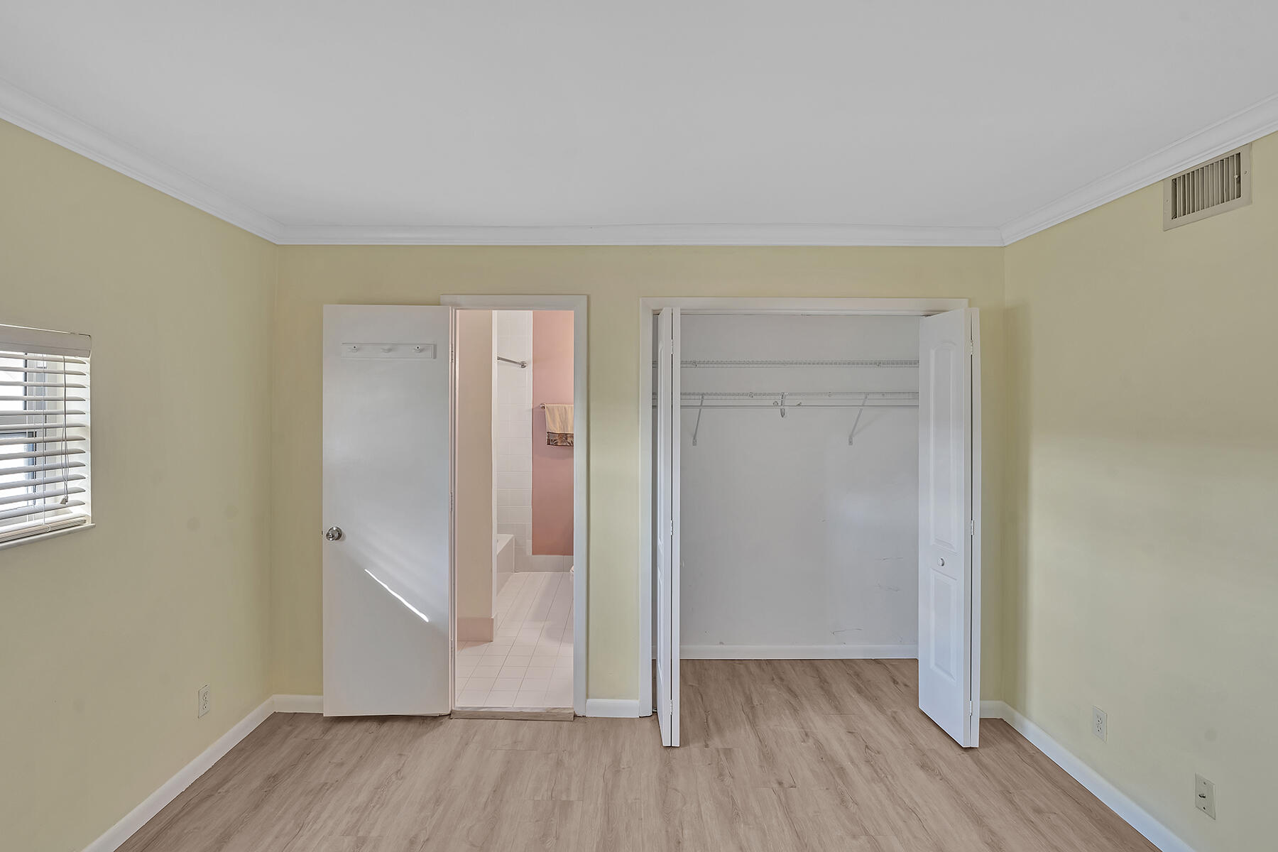 1945 Northwest 4th Avenue, Unit 32C Boca Raton, FL 33432 - Photo 38 of 52 an empty room with wooden floor & windows