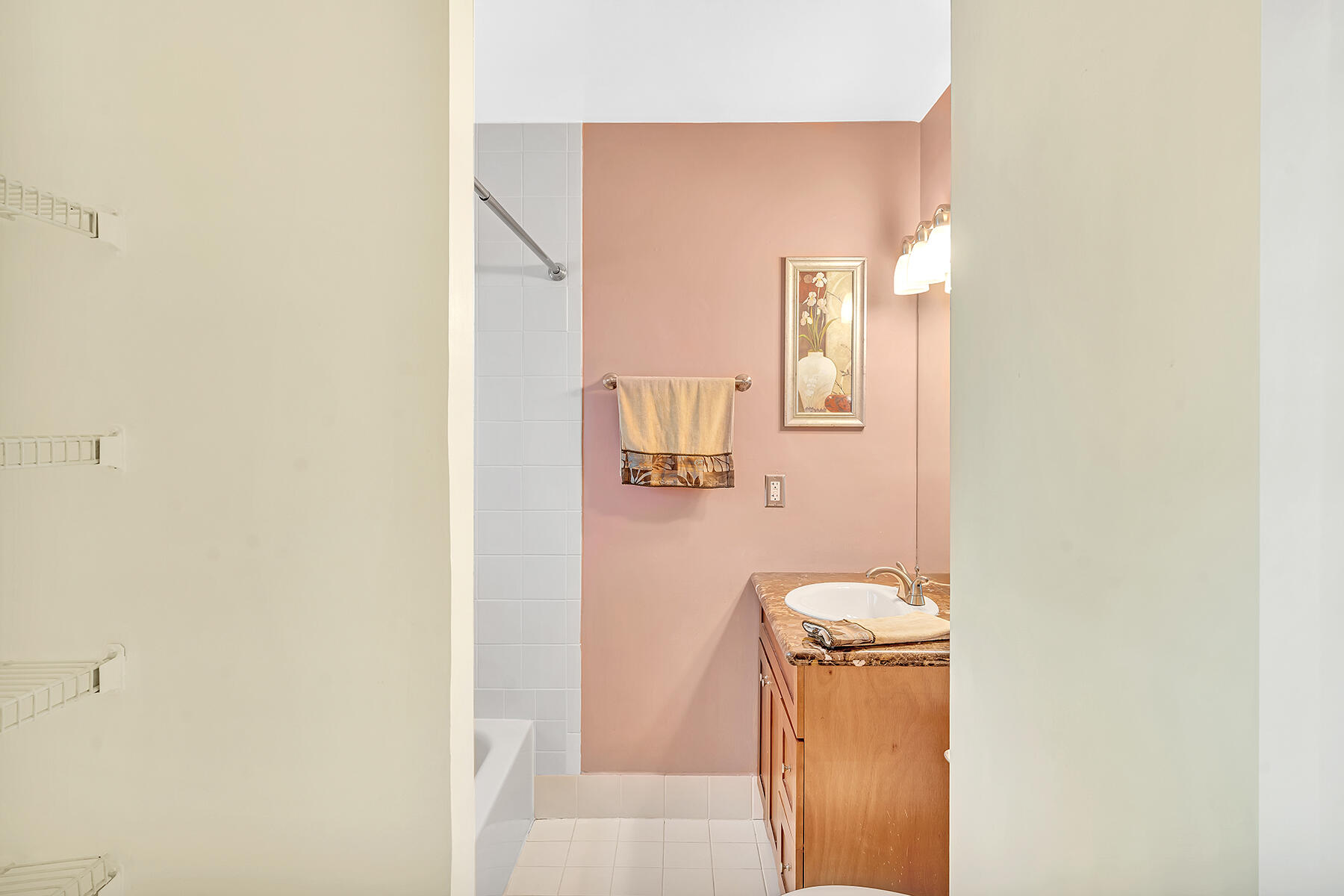 1945 Northwest 4th Avenue, Unit 32C Boca Raton, FL 33432 - Photo 40 of 52 a bathroom with a sink and mirror