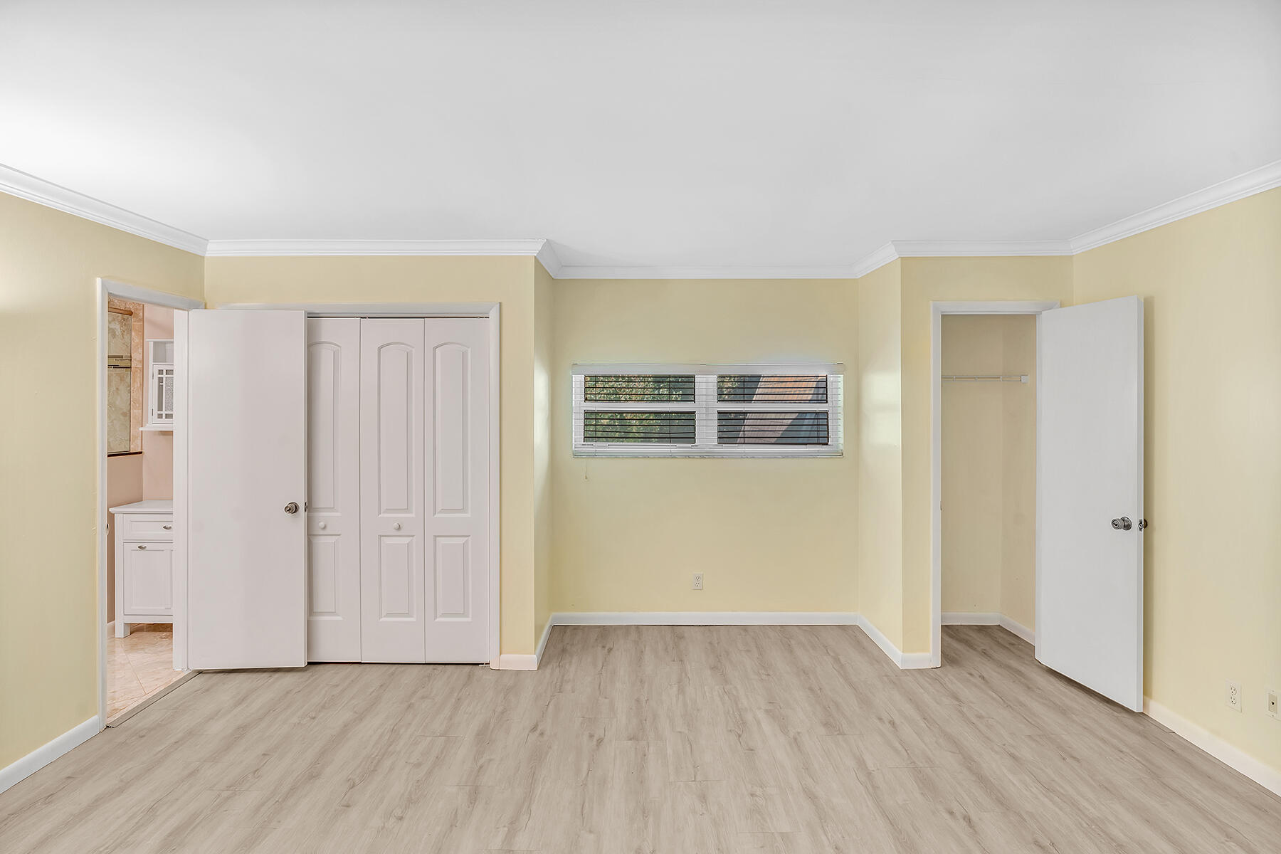 1945 Northwest 4th Avenue, Unit 32C Boca Raton, FL 33432 - Photo 44 of 52 an empty room with wooden floor and windows