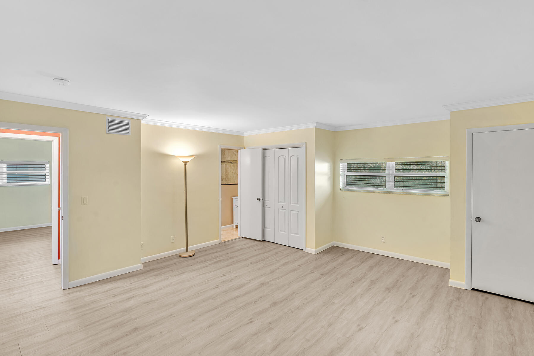 1945 Northwest 4th Avenue, Unit 32C Boca Raton, FL 33432 - Photo 45 of 52 an empty room with wooden floor and windows