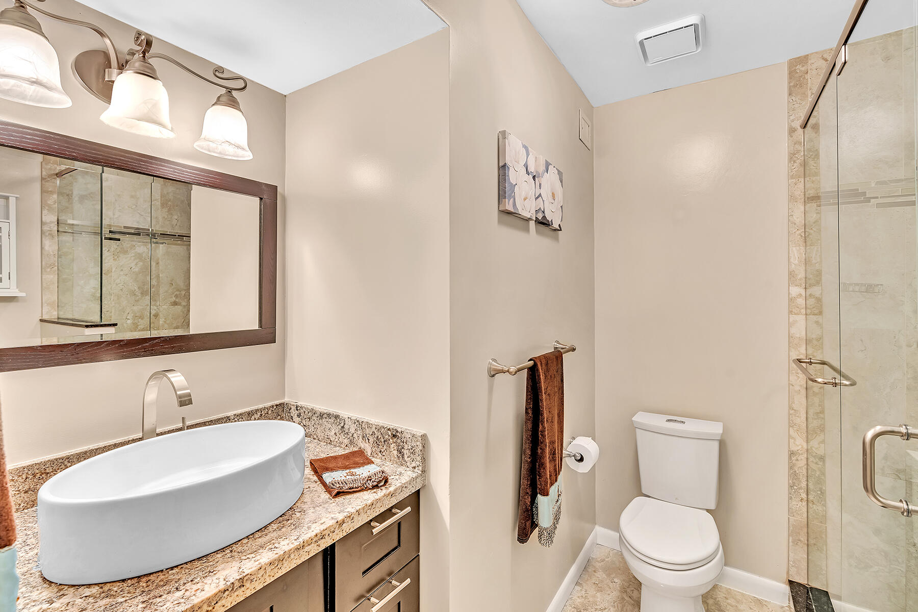 1945 Northwest 4th Avenue, Unit 32C Boca Raton, FL 33432 - Photo 49 of 52 a bathroom with a toilet sink and a mirror