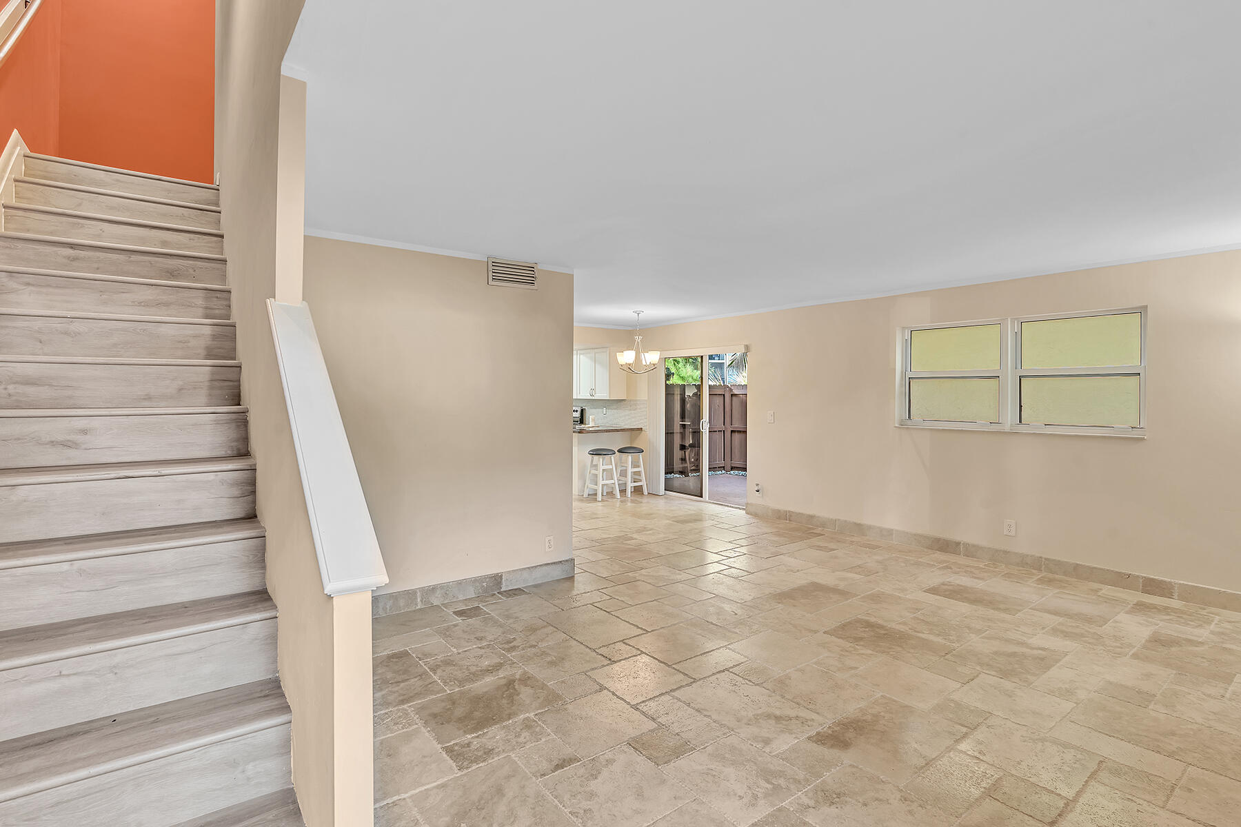 1945 Northwest 4th Avenue, Unit 32C Boca Raton, FL 33432 - Photo 7 of 52 a view of an empty room with stairs and ventilation