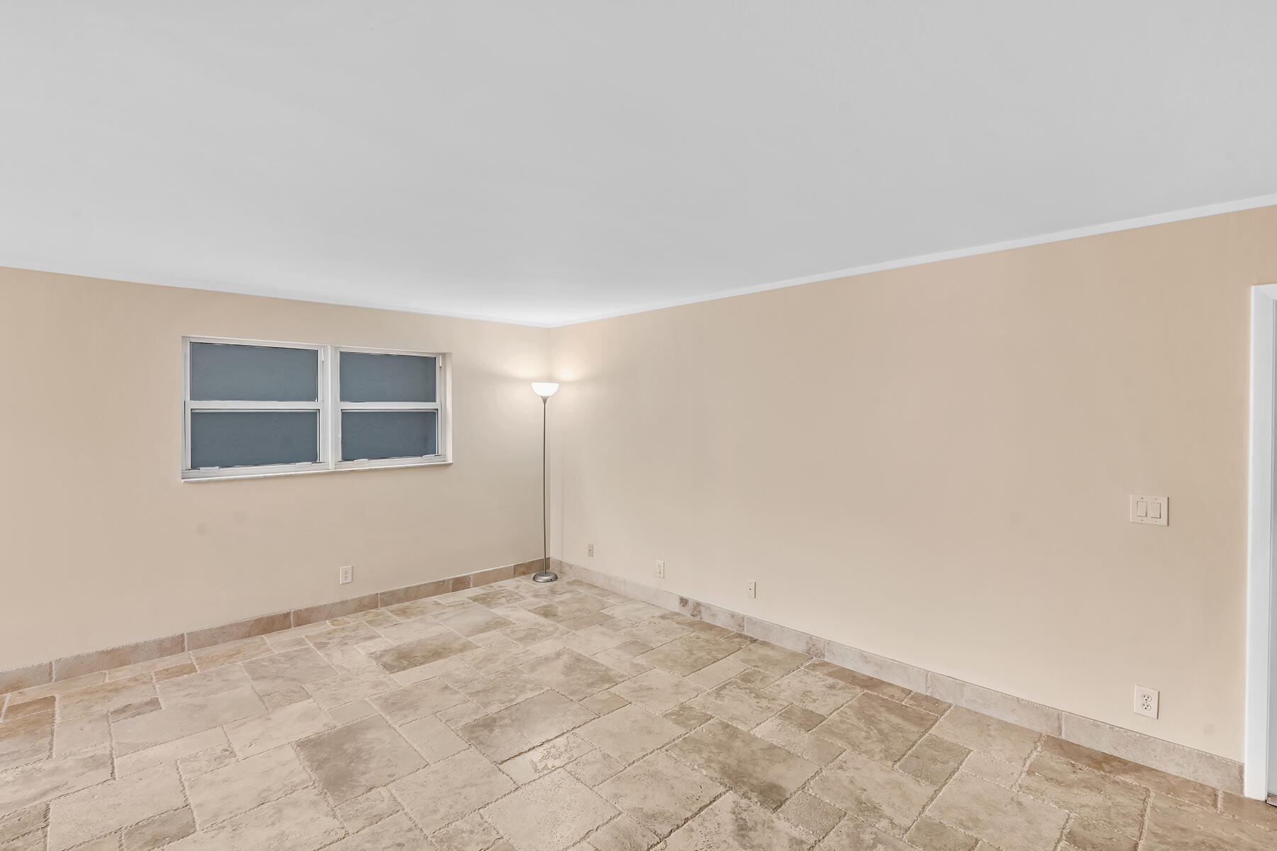 1945 Northwest 4th Avenue, Unit 32C Boca Raton, FL 33432 - Photo 10 of 52 a view of an empty room with a window