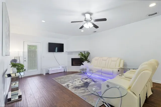 a living room with furniture and wooden floor