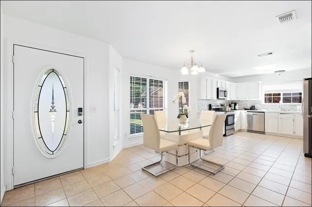 a living room with furniture a table and chairs