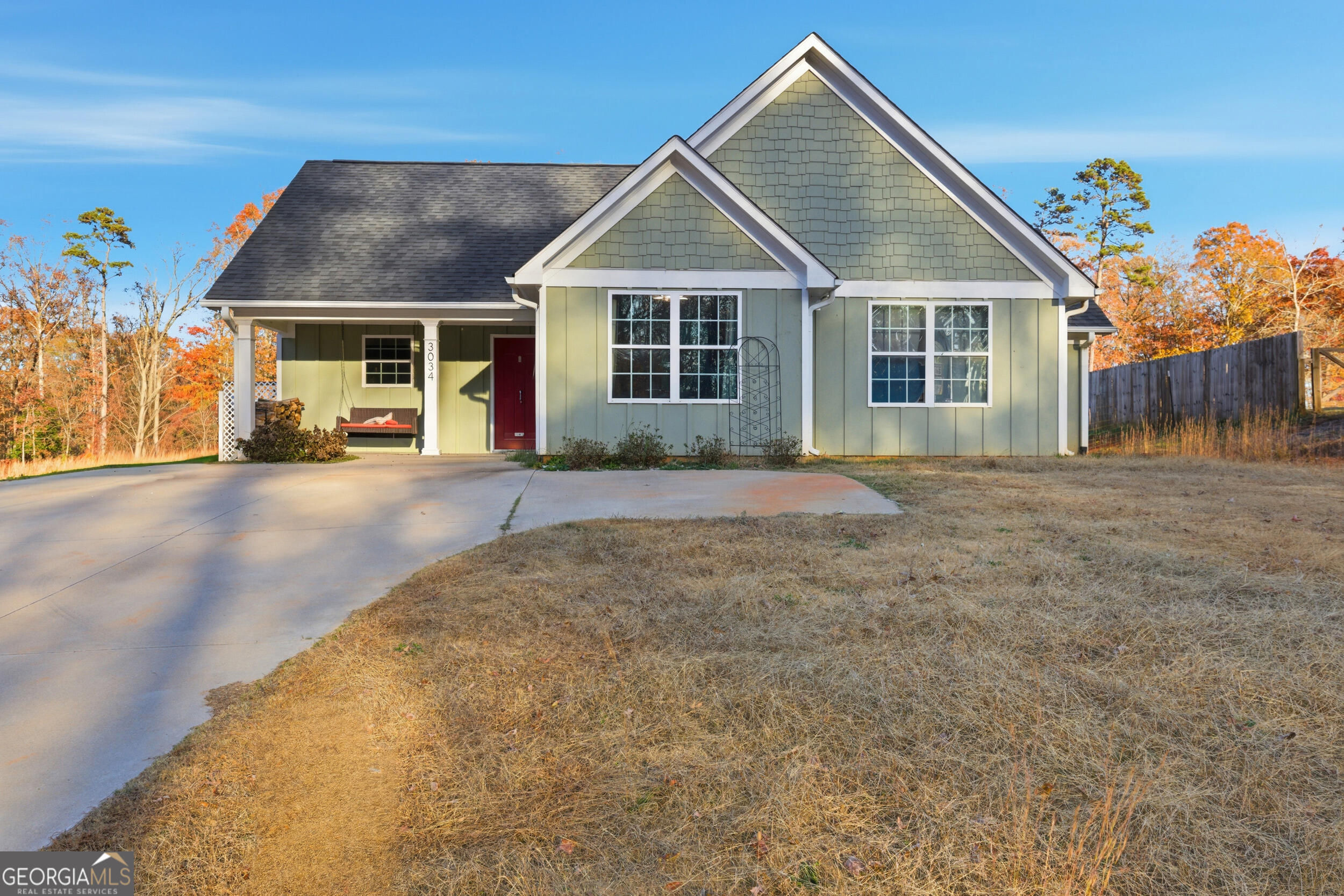 a view of a house with a yard and potted plants