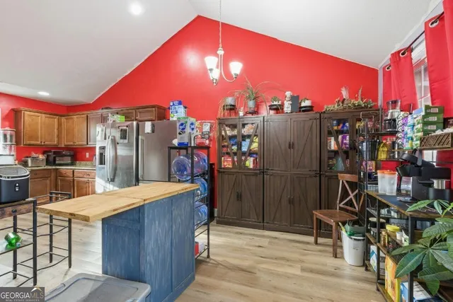 an empty room with wooden floor and cabinet