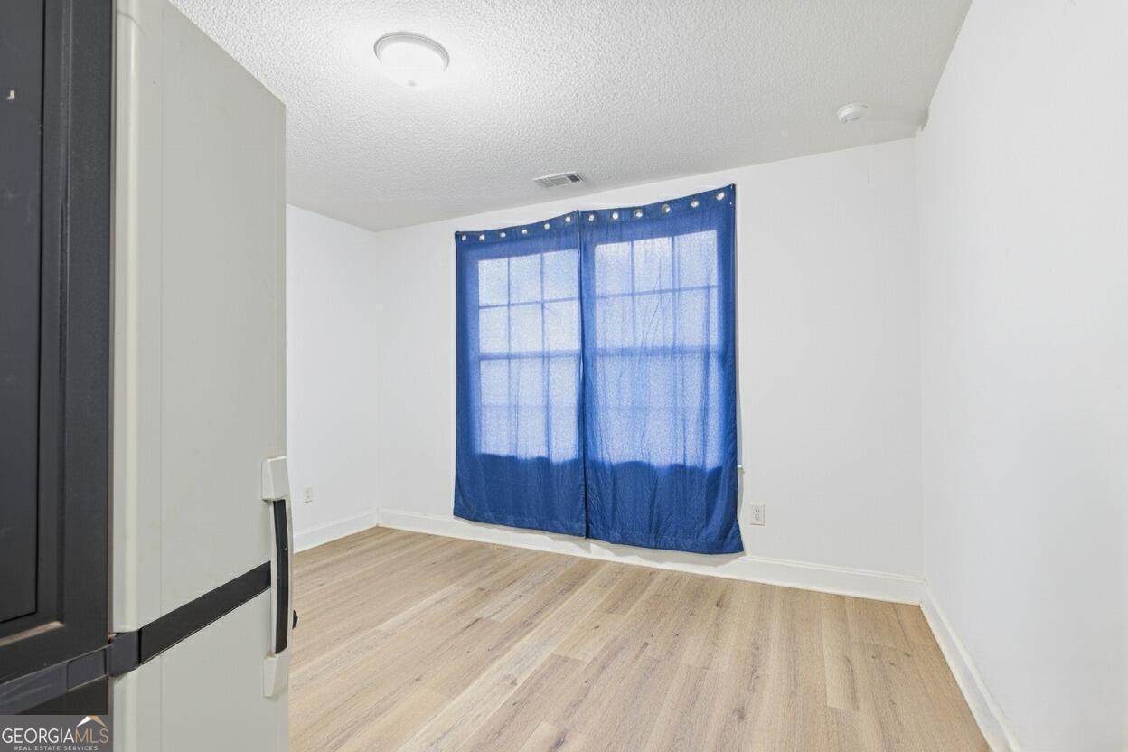 3034 Mt Hebron Road Hartwell, GA 30643 - Photo 12 of 21 an empty room with wooden floor and cabinet