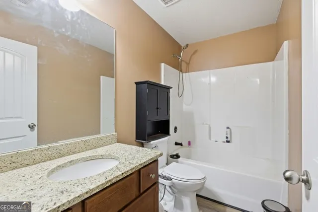 a bedroom with a bed and cabinets