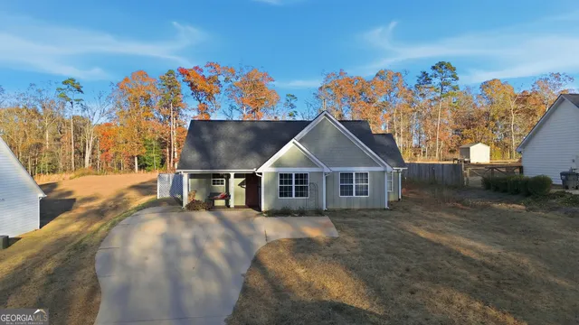 a view of a house with a wooden fence