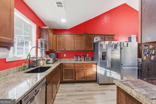 a kitchen with lots of counter top space and stainless steel appliances
