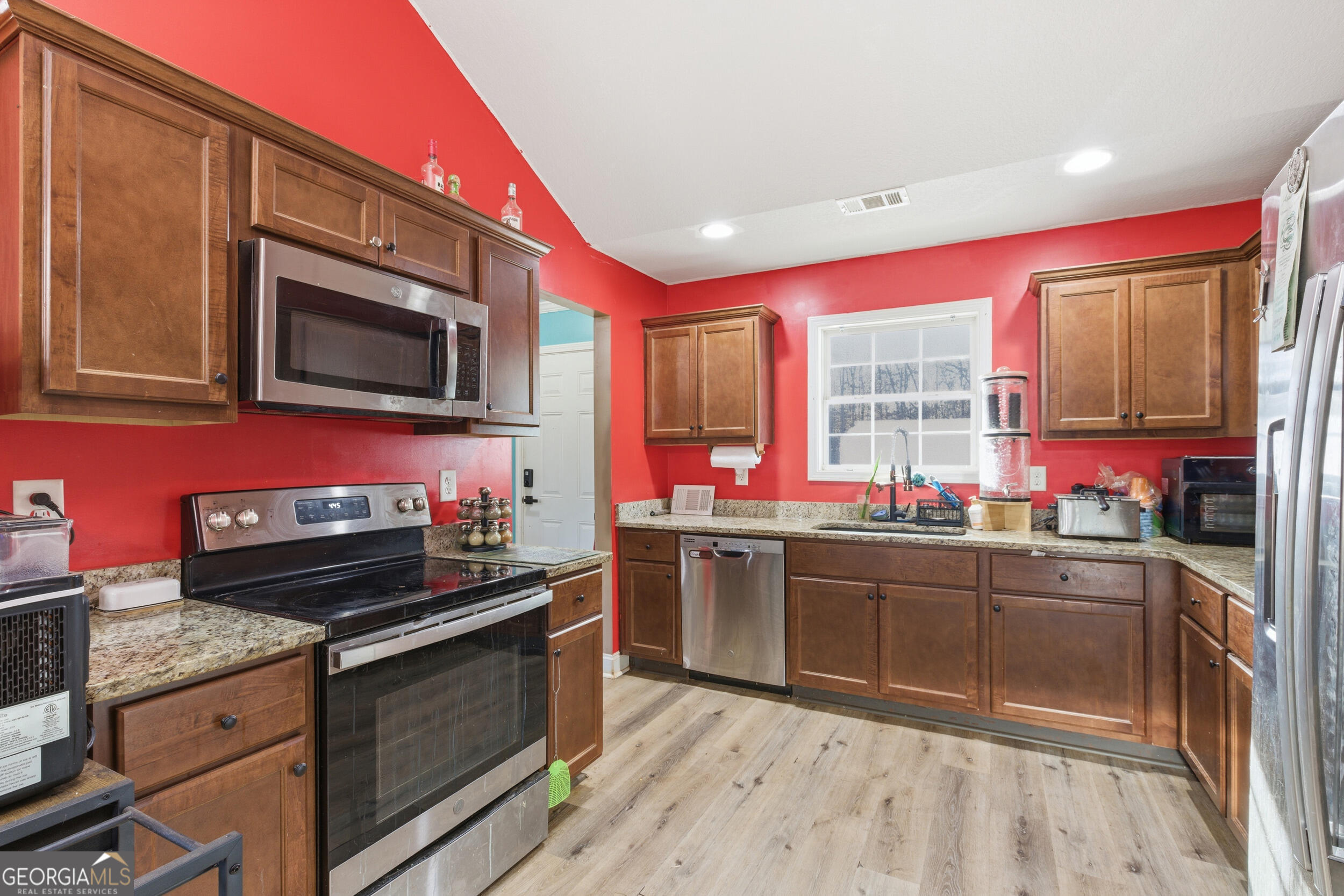 3034 Mt Hebron Road Hartwell, GA 30643 - Photo 10 of 21 a kitchen with stainless steel appliances kitchen island granite countertop a stove sink and microwave