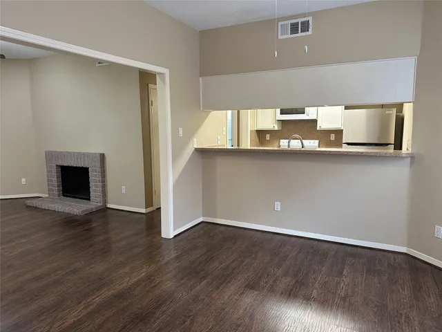 a kitchen with a wooden floor and a window