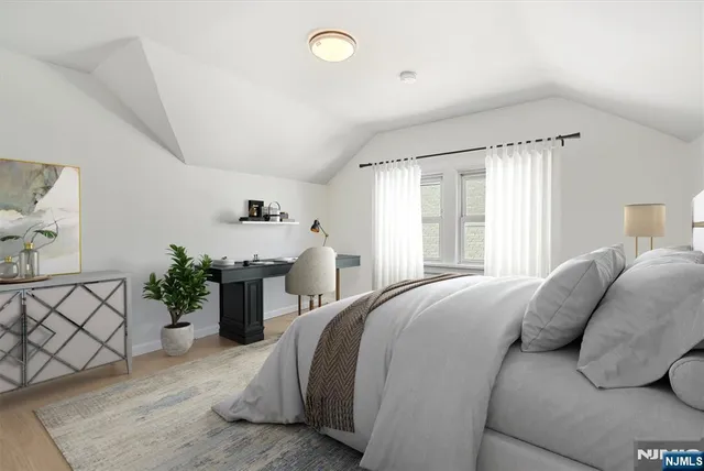 a spacious bedroom with a bed and a couch