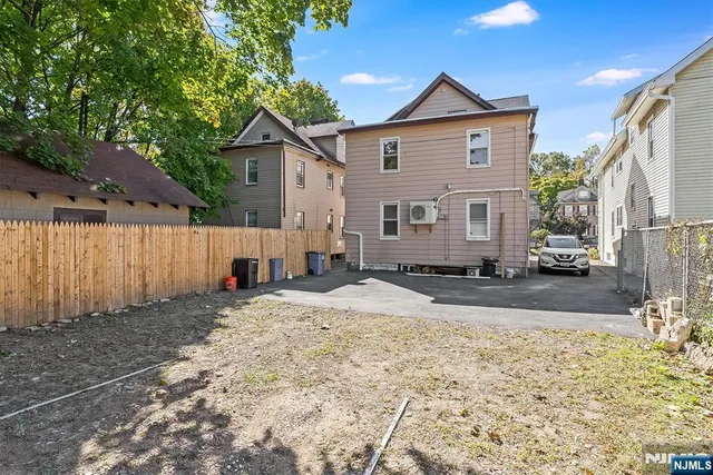 a view of a house with a yard covered in the background