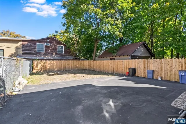 a view of a house with backyard and a tree