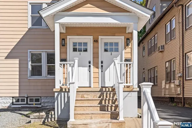 a front view of a house with large windows