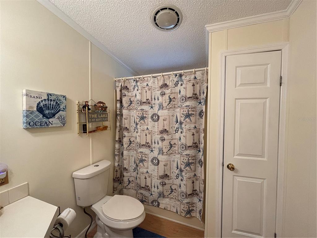 1759 Southwest 35th Circle Okeechobee, FL 34974 - Photo 12 of 29 a white toilet sitting next to a shower curtain