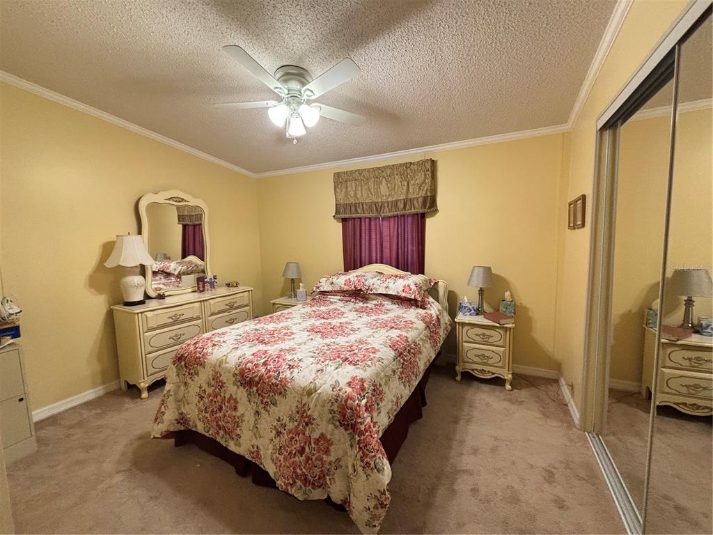 1759 Southwest 35th Circle Okeechobee, FL 34974 - Photo 13 of 29 a bed room with a bed and a chandelier