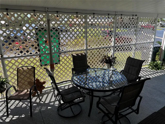 a view of a chairs and table in a backyard