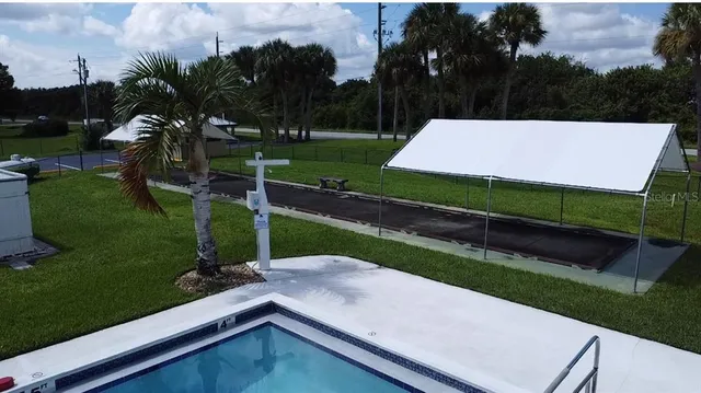 an aerial view of a house with swimming pool and garden