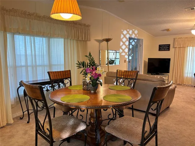 a dining room with furniture and window