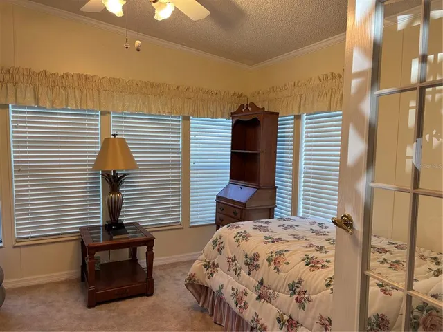 a bedroom with a bed and a night stand