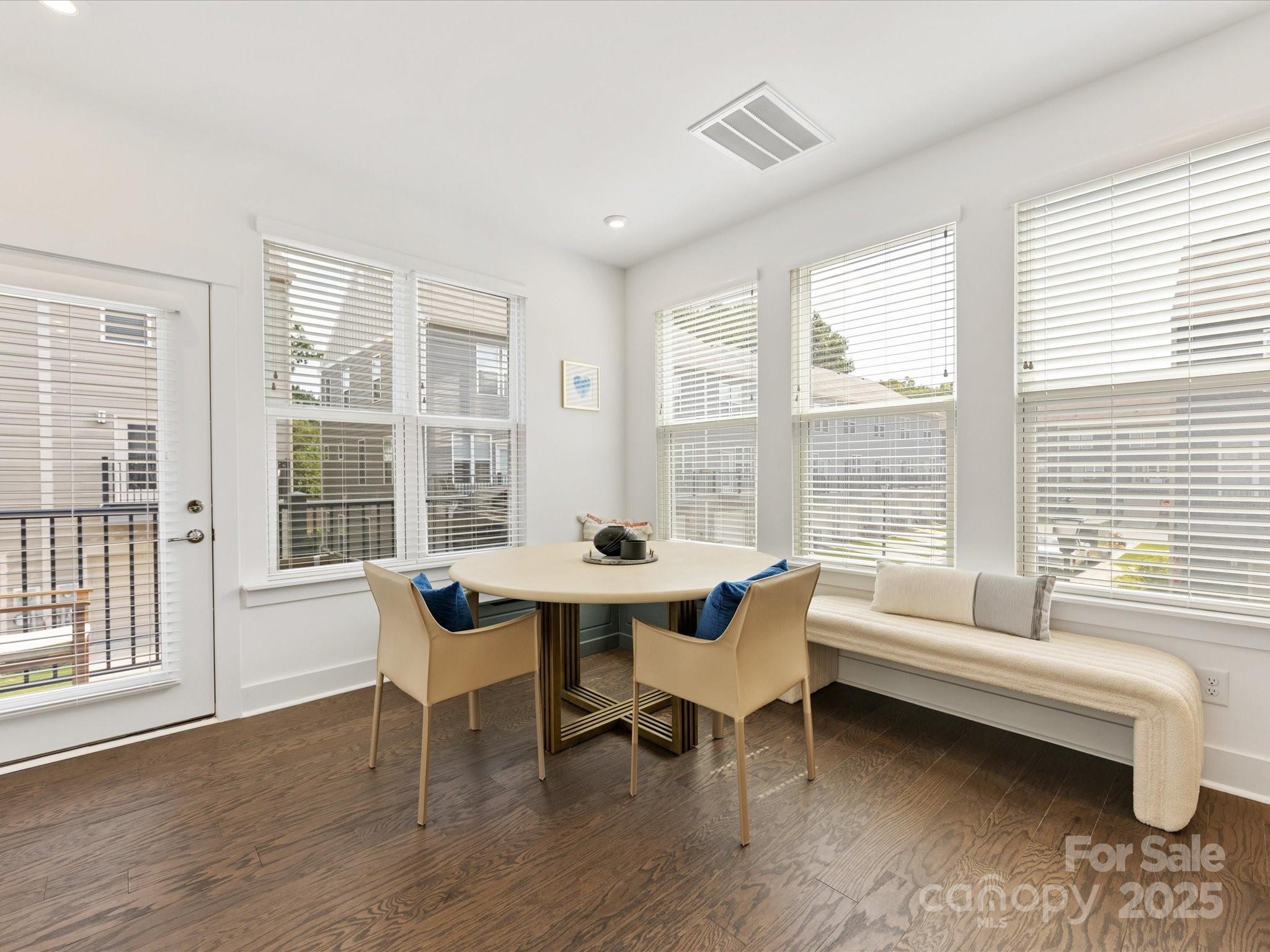 4027 Capital Ridge, Unit 10 Charlotte, NC 28205 - Photo 16 of 34 a dining room with wooden floor and a floor to ceiling window