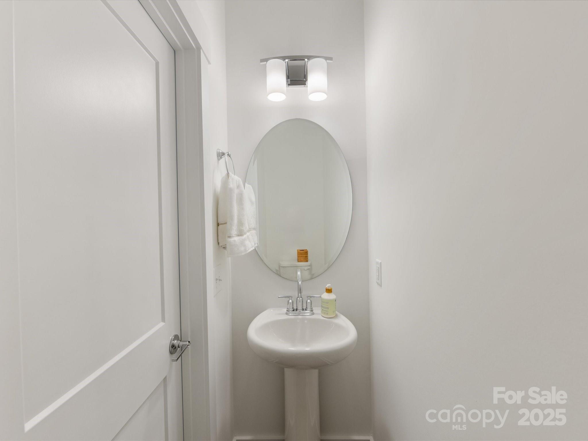 4027 Capital Ridge, Unit 10 Charlotte, NC 28205 - Photo 19 of 34 a bathroom with a sink and a mirror