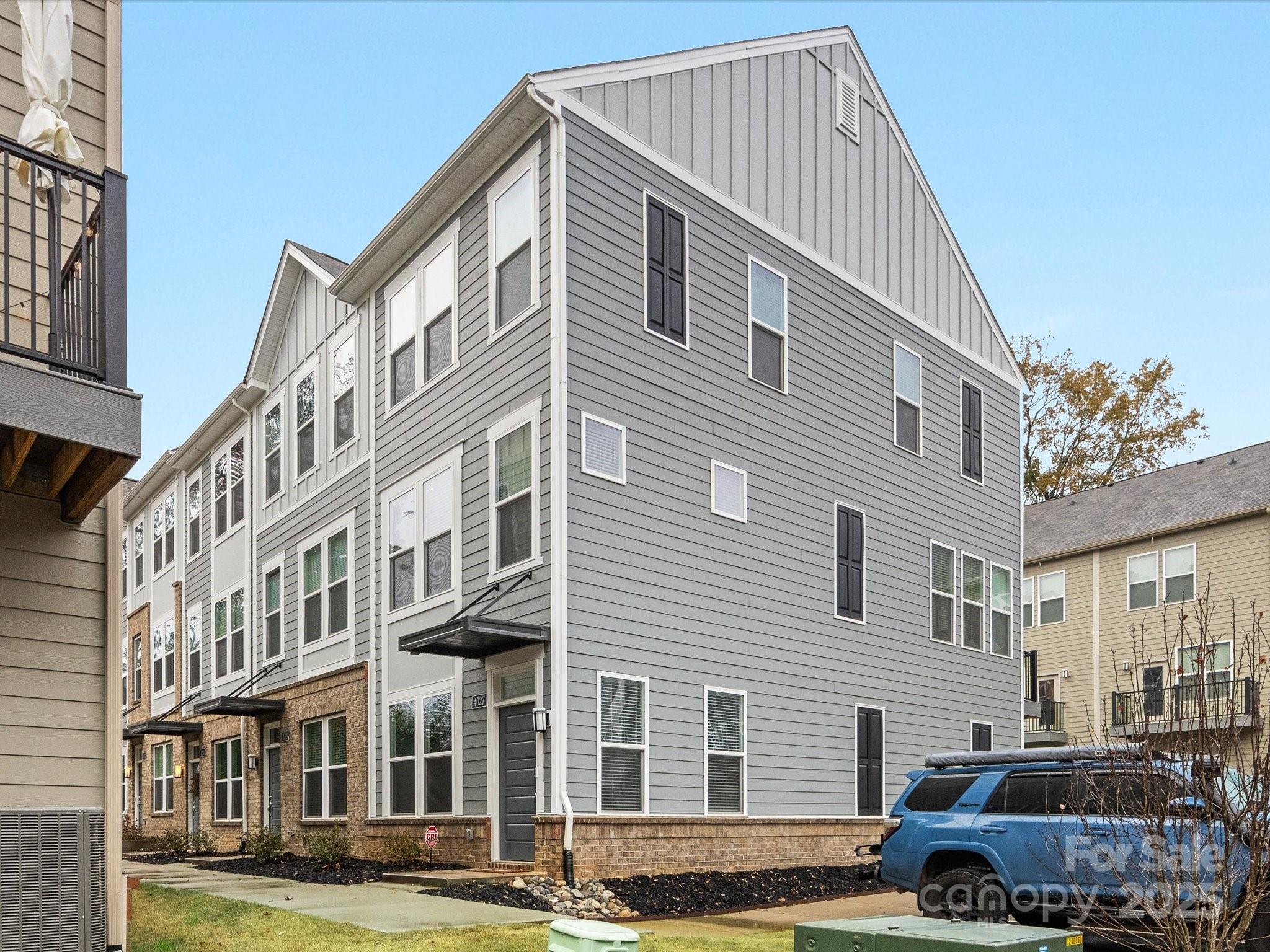 4027 Capital Ridge, Unit 10 Charlotte, NC 28205 - Photo 2 of 34 a front view of a residential apartment building with a yard