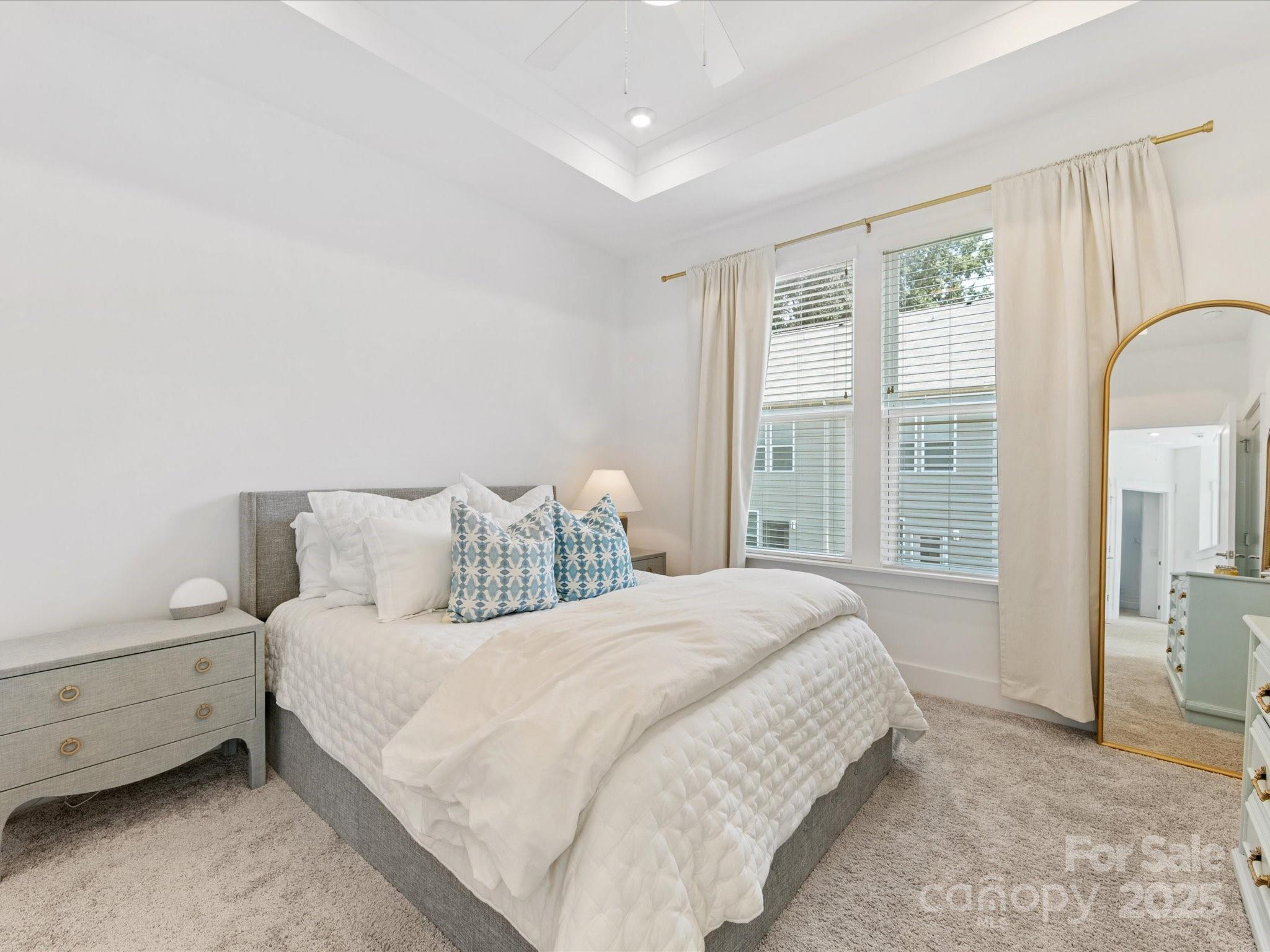 4027 Capital Ridge, Unit 10 Charlotte, NC 28205 - Photo 24 of 34 a bedroom with a bed a mirror and a window