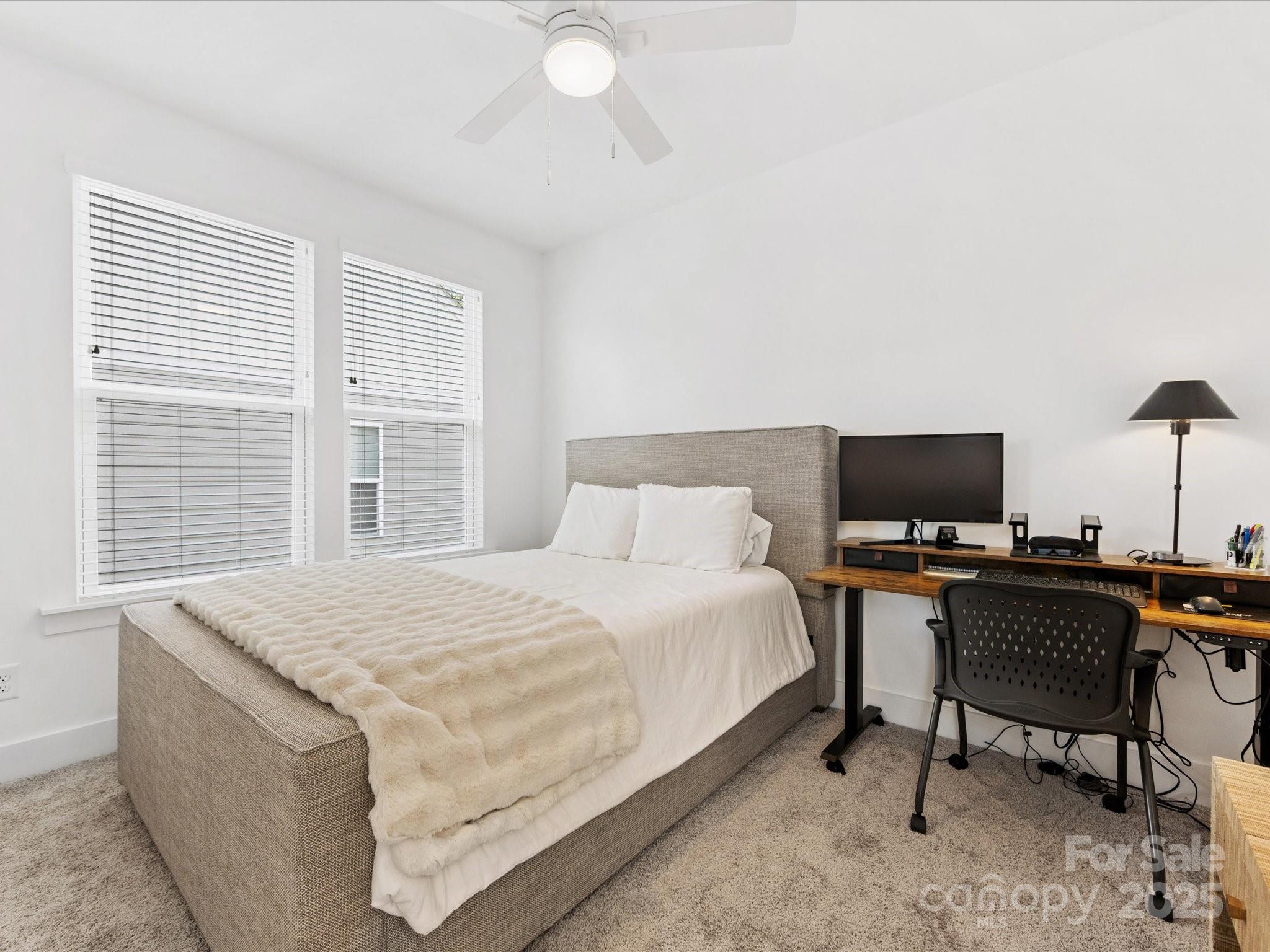 4027 Capital Ridge, Unit 10 Charlotte, NC 28205 - Photo 28 of 34 a bedroom with a bed and a computer on a table