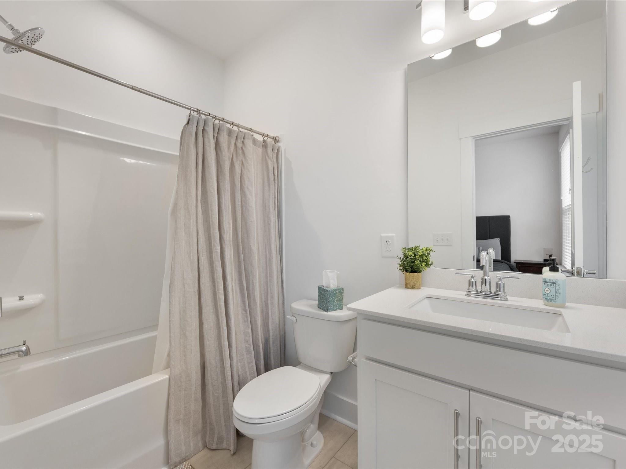 4027 Capital Ridge, Unit 10 Charlotte, NC 28205 - Photo 30 of 34 a bathroom with a sink a toilet a mirror and shower
